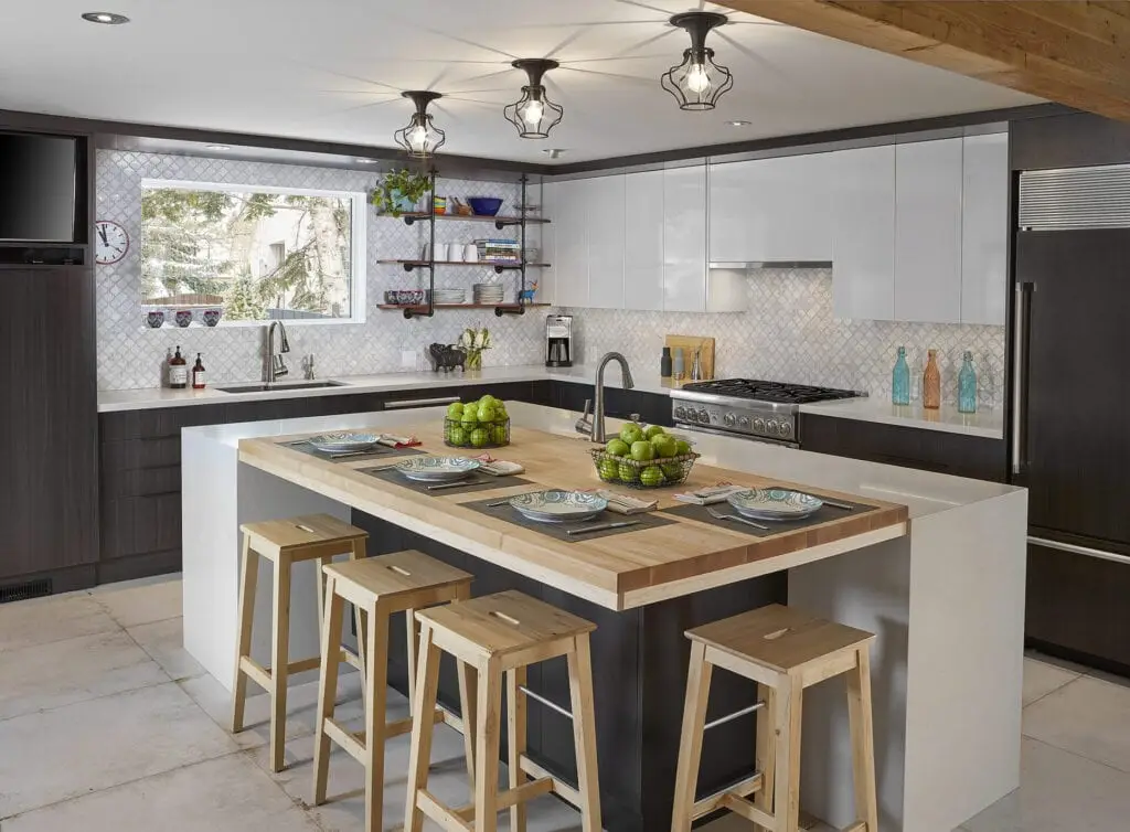 Bright contemporary kitchen with white and dark cabinetry, large window, island, and seating area.