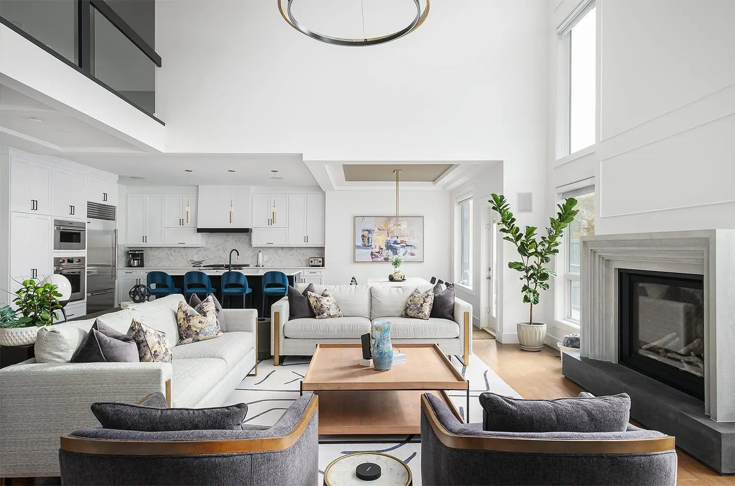 Bright living space with cozy sofas, stylish decor, and a fireplace, ideal for family gatherings.