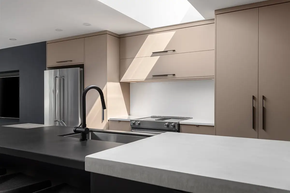 Sleek kitchen design featuring beige cabinetry and black fixtures for contemporary style.