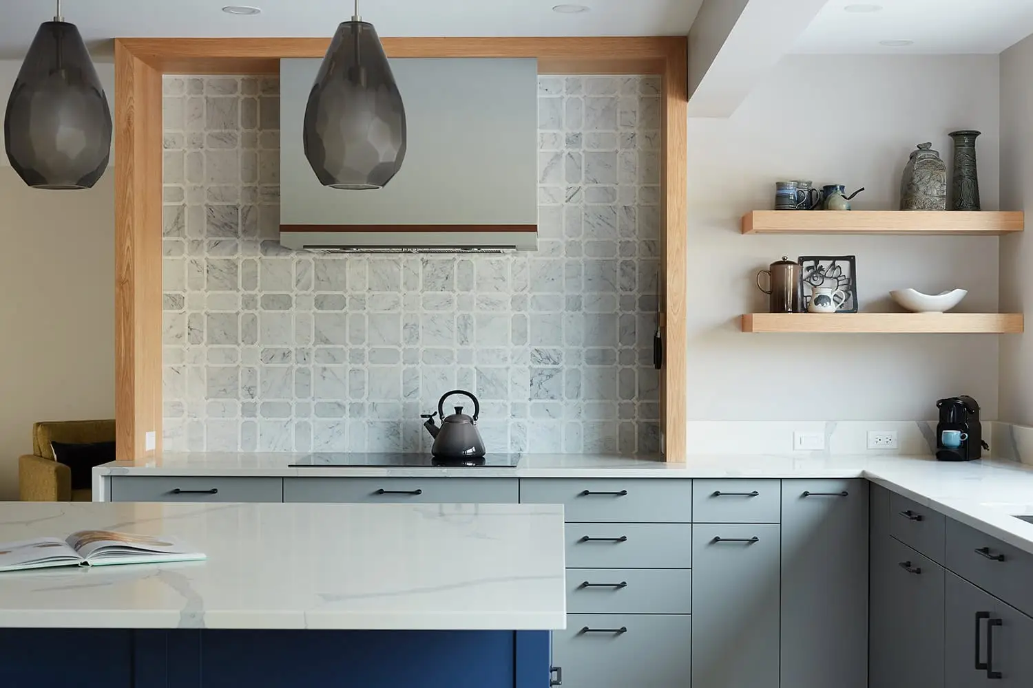Kitchen decor with gray cabinetry, open shelves, and decorative ceramics, creating a contemporary and cozy ambiance.