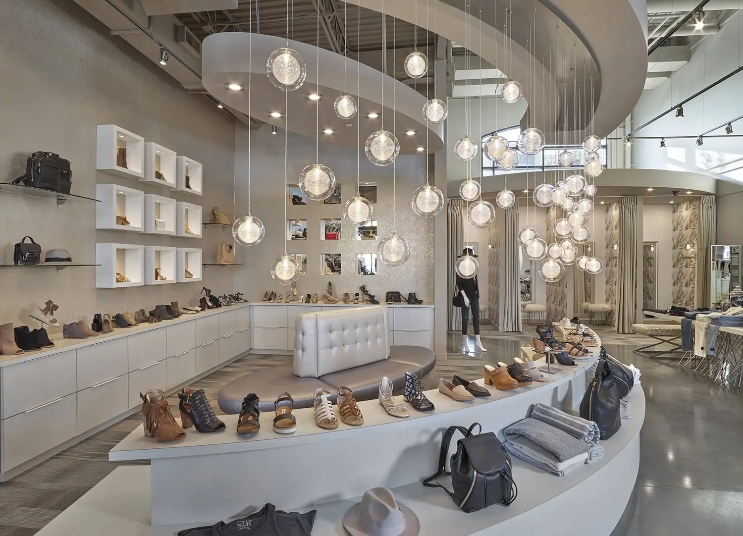 Bright and elegant shoe store interior showcasing a variety of footwear and accessories.